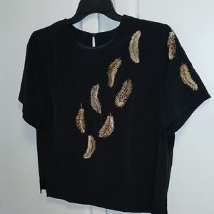 Black petite shell with embellished golden design and wide neckline. SZ SP